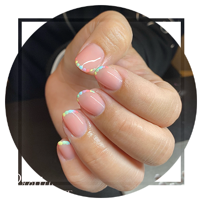 Clear coated nails with variuos coloured dots along tips Clear coated nails with dots